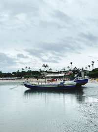Boats in sea against sky