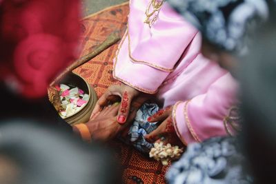 High angle view of hands holding flower