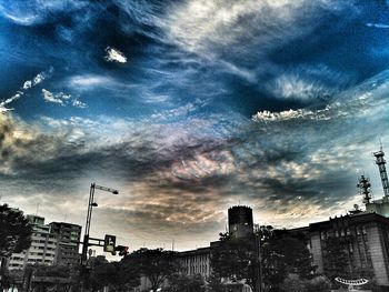 Buildings against cloudy sky