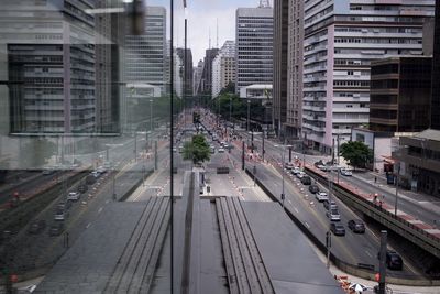 High angle view of traffic on road amidst buildings in city