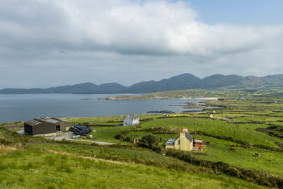 Scenic view of sea and mountains against sky