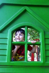 Smiling boy seen through window