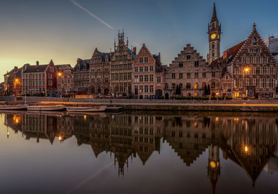 Reflection of historical buildings in canal at night