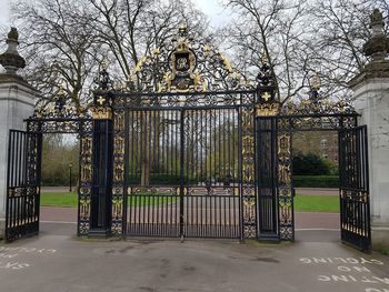 Metal gate in park against building