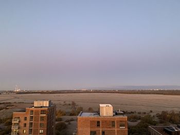 High angle view of buildings against clear sky