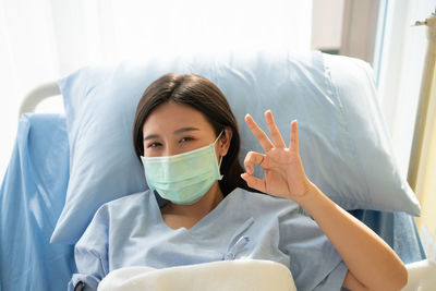 Portrait of a beautiful young woman lying in bed