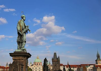 Low angle view of statue of historic building against sky