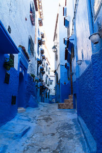 Narrow alley amidst buildings in city during winter