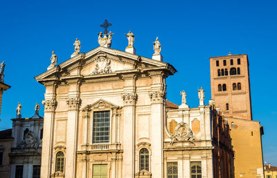 Low angle view of historical building against clear blue sky