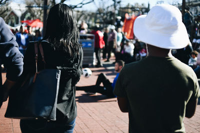 Rear view of people on street in city