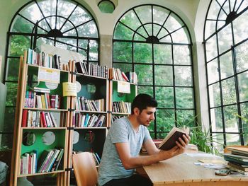 Man reading book at library