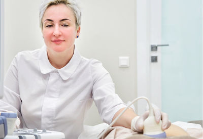 Gynecologist examining patient at hospital