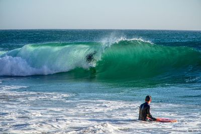 Man in sea against clear sky