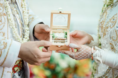 Midsection of woman holding hands