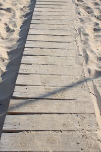 High angle view of wood shadow on sand
