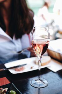 Glass of woman sitting on table