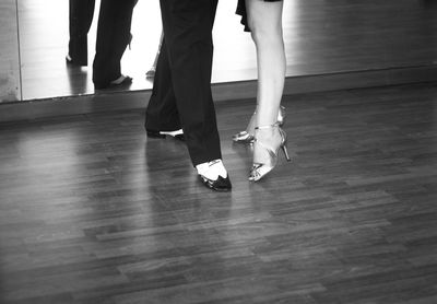 Low section of people dancing on hardwood floor