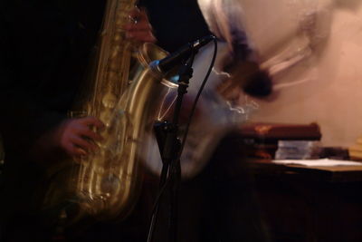 Close-up of man playing guitar