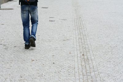 Low section of woman standing on tiled floor