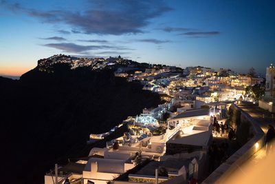 High angle view of illuminated buildings in town against sky