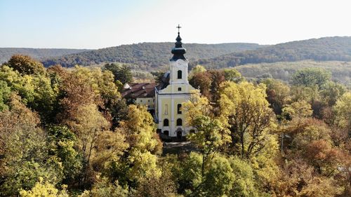 Panoramic view of trees and buildings against sky