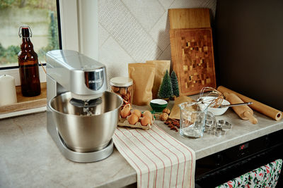 Electric mixer kneads dough in the kitchen