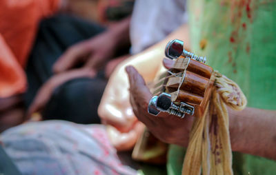 Close-up of man playing guitar