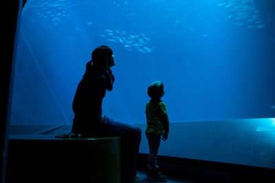 Man swimming in aquarium