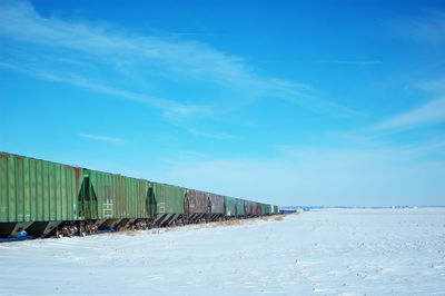 Vanishing point of freight cars on the snow covered prairie