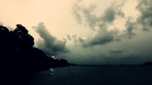 Scenic view of sea against storm clouds