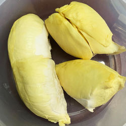 Close-up of yellow fruits in plate on table