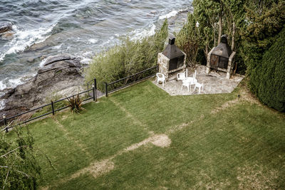 High angle view of grass by sea