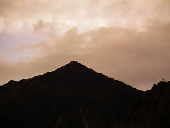 Silhouette mountain against sky during sunset