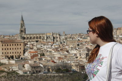 Tourist against toledo cityscape