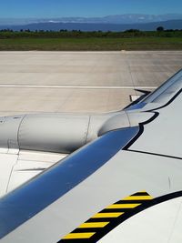 Airplane on airport runway against blue sky