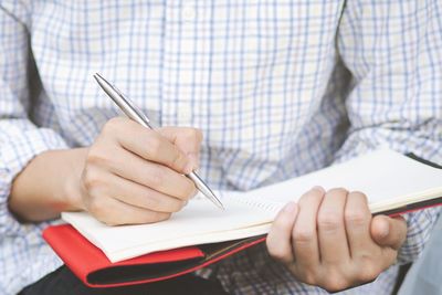 Close-up of man reading book