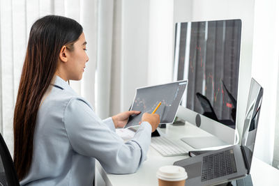 Young woman using laptop at office