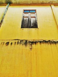 Low angle view of yellow window