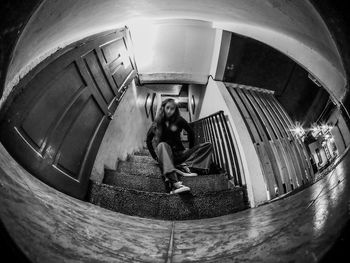 High angle view of woman standing on escalator