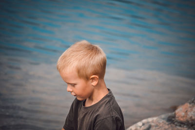 Portrait of boy looking at sea