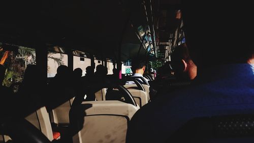 Rear view of man sitting in airplane