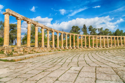 View of columns in city against sky