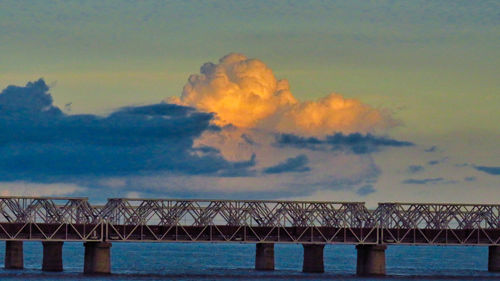 Low angle view of bridge over sea against sky