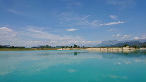 Scenic view of lake against blue sky