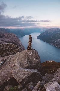 Rock pile and view of norwegian fjords in cloudy day