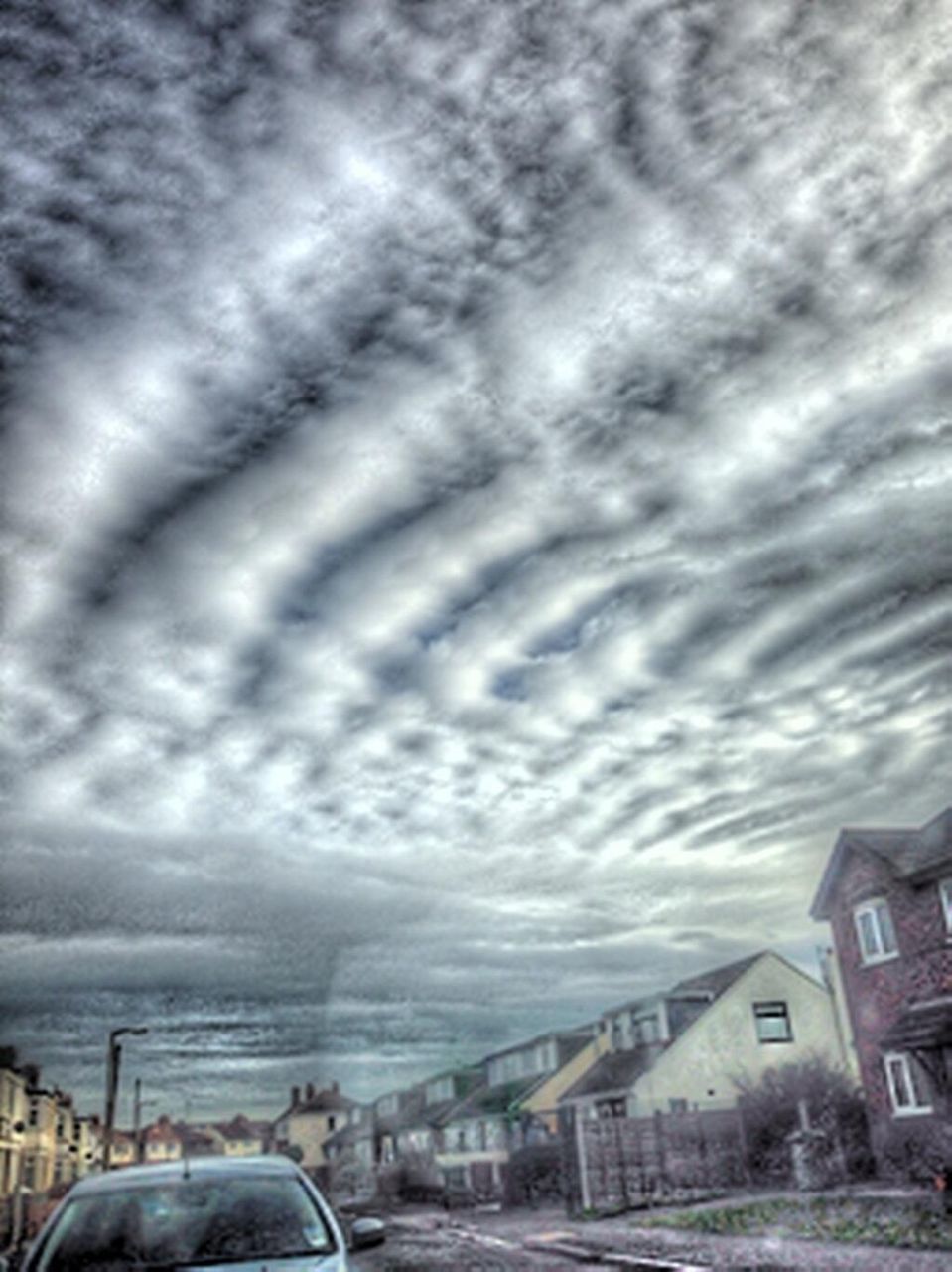 building exterior, sky, cloud - sky, architecture, built structure, transportation, cloudy, car, city, land vehicle, mode of transport, weather, cloud, road, overcast, street, residential building, cloudscape, outdoors, house