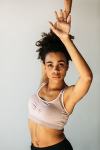 Portrait of woman standing against white background