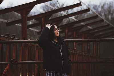 Full length of woman standing by railing