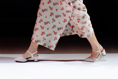 Fancy outfit of white skirt with floral print, fashion details of women's casual cloth