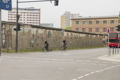 People walking on street against buildings in city